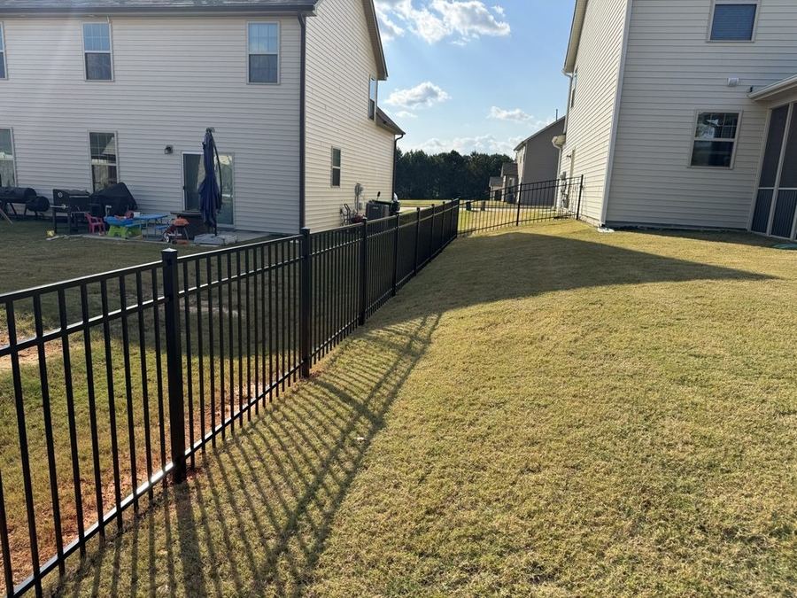 Black aluminum fence on corner lot