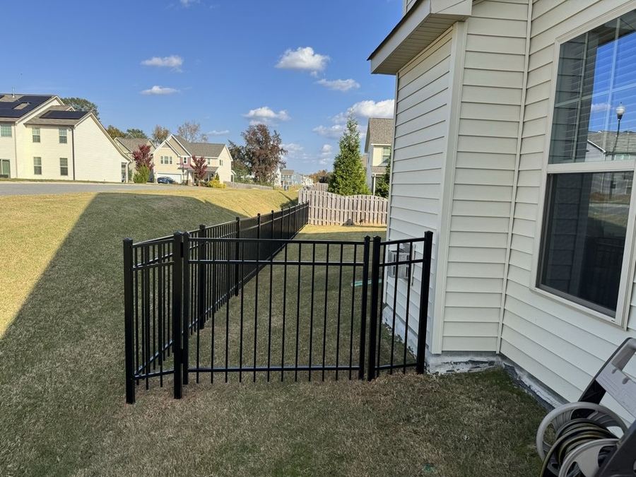 Black aluminum fence with arched walk gate