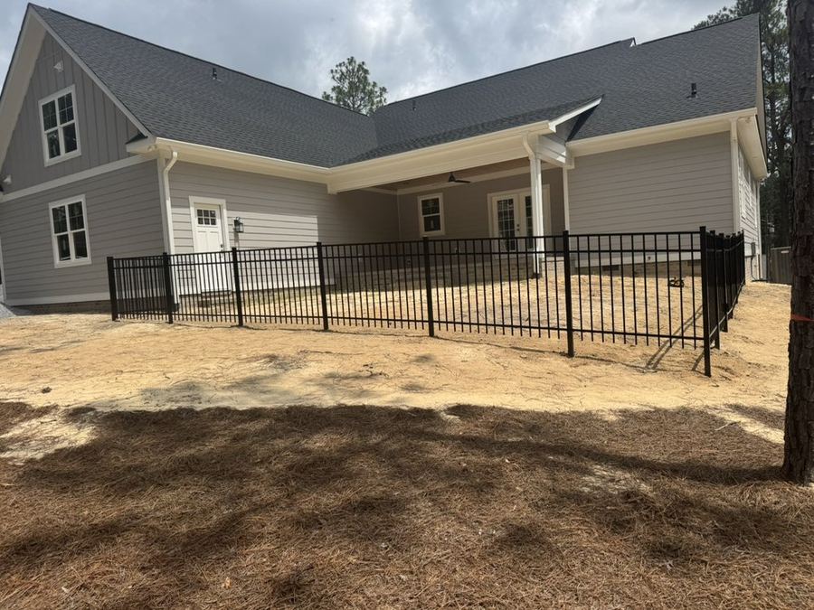 Black aluminum fence on property line