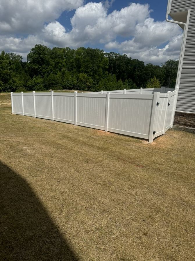 White vinyl privacy fence enclosing a residential backyard in the Triangle NC area