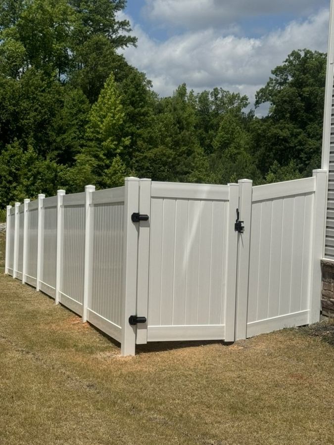 White vinyl fence along property line