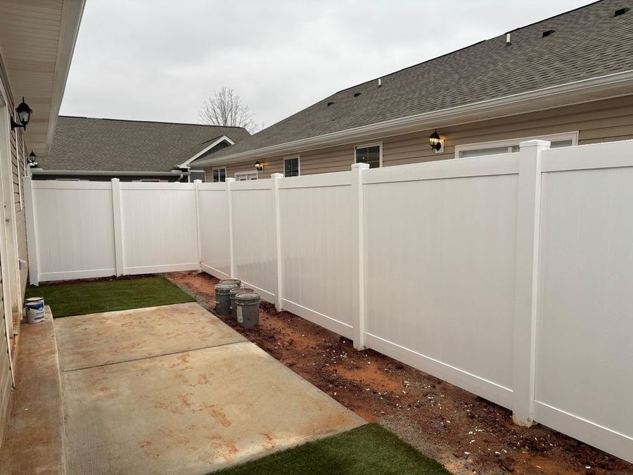 White vinyl privacy fence along a residential patio in the Triangle NC area