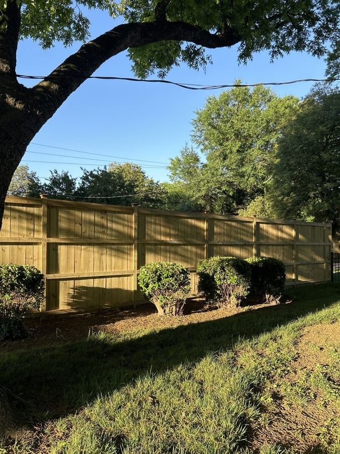 Wood cap and trim fence with routed rails