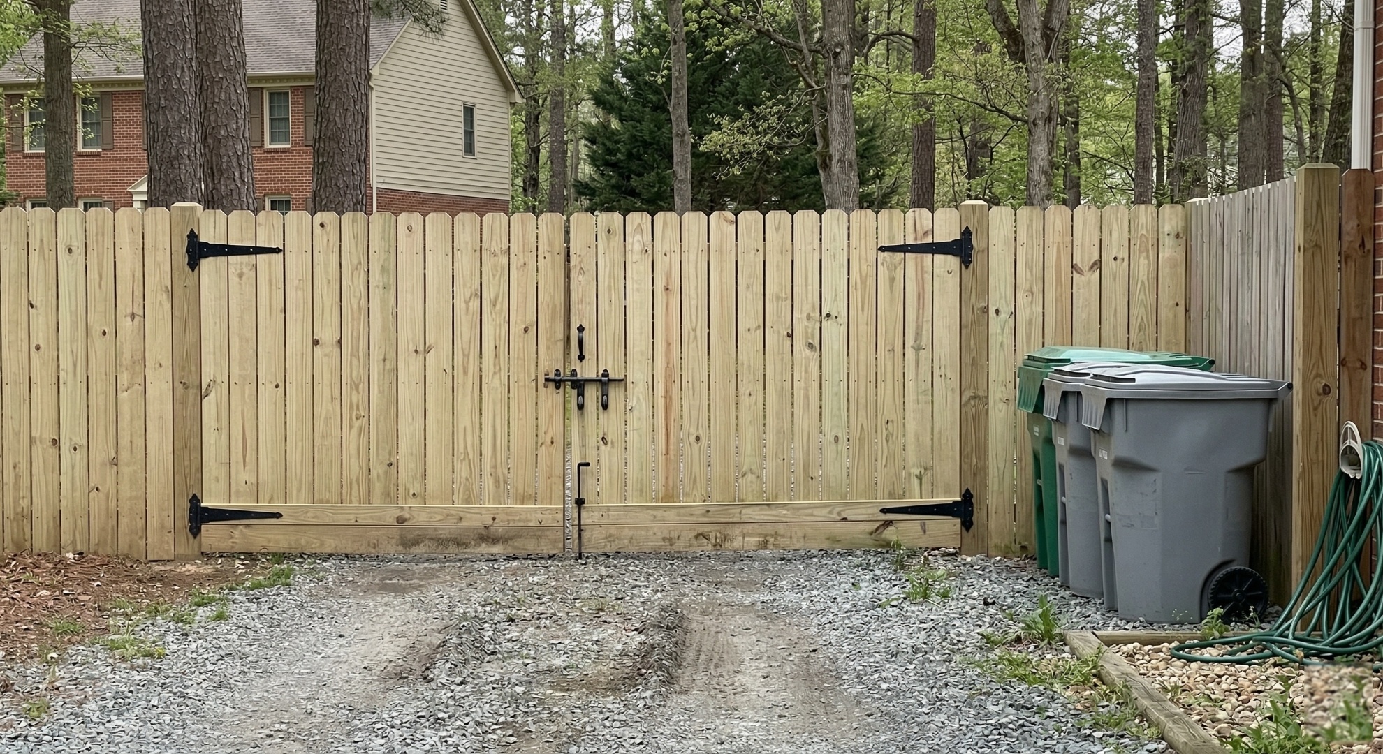 Brand new pressure-treated wood privacy fence with double drive-through gate