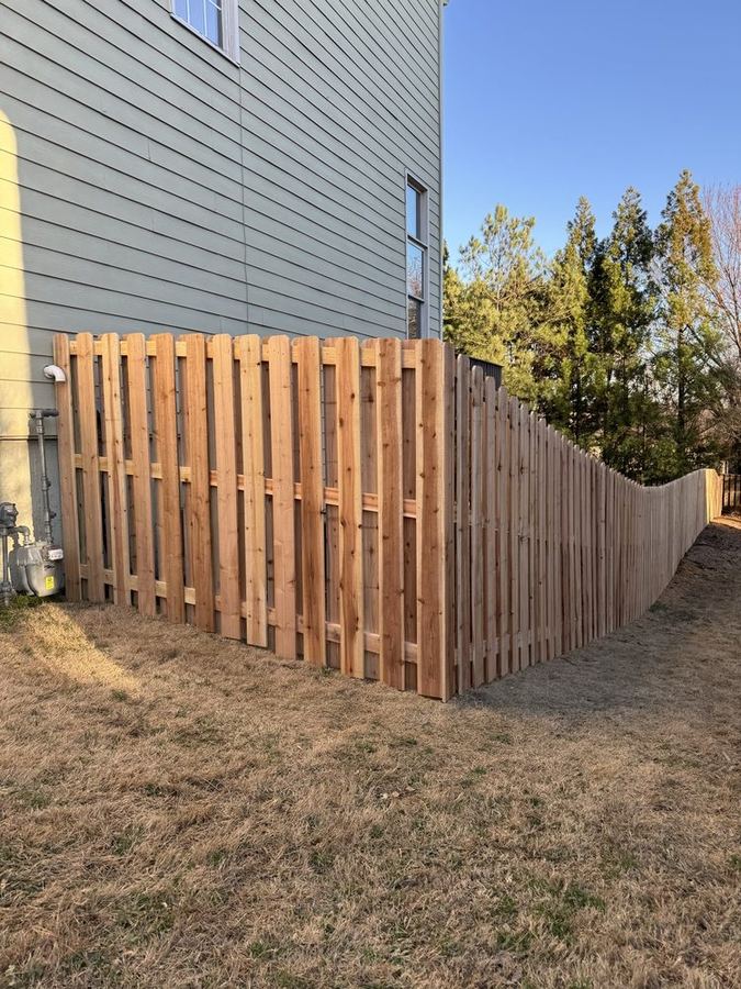 Shadowbox wood fence corner detail in a residential backyard
