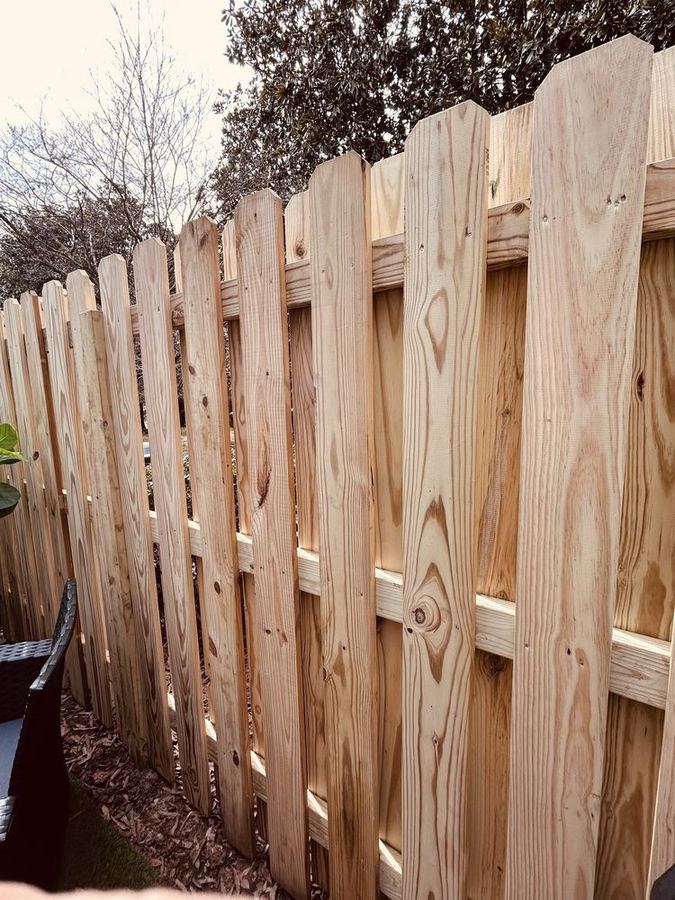 Shadow box wood fence with alternating pickets